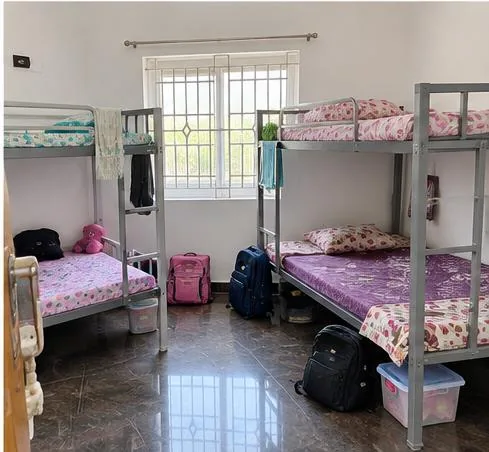 Room at Nilaa Stay with cots and storage